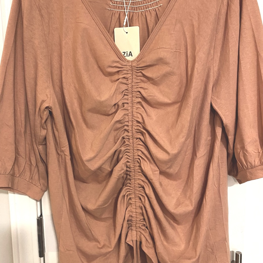 Ladies deep peach top. The color was hard to get right. The dark ones are closer